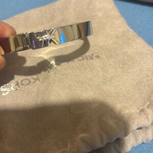 This is a silver tone, Michael Kors bracelet